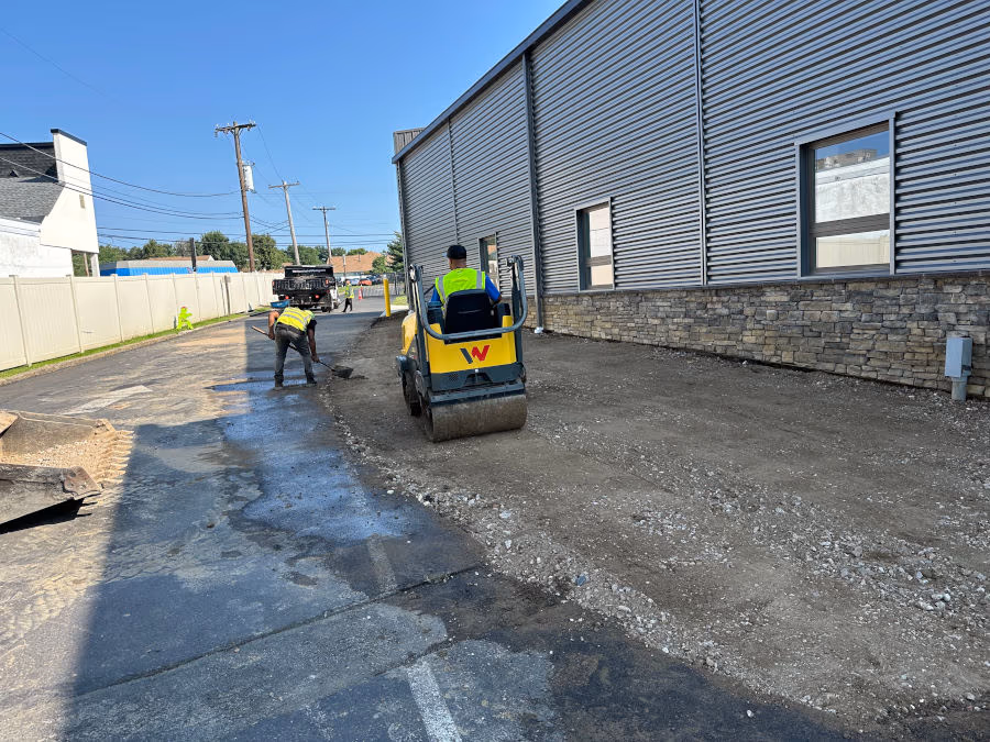 Harrison Asphalt crew compacting a commercial base
